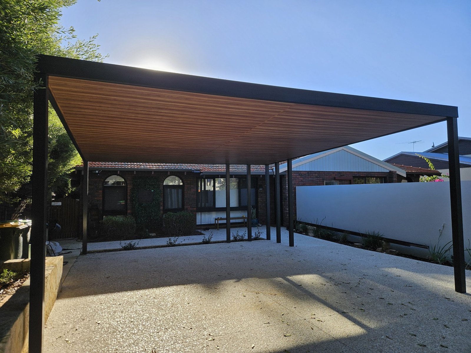 Modern flat roof steel patio with timber-look ceiling on a Perth home